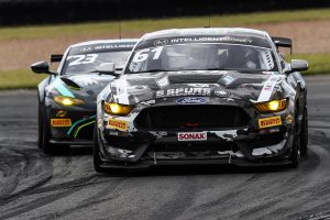 Marco Signoretti battling an Aston Martin during the British GT at Donington in the #61 Academy Motorsport Ford Mustang GT4 on Forgeline GS1R Wheels